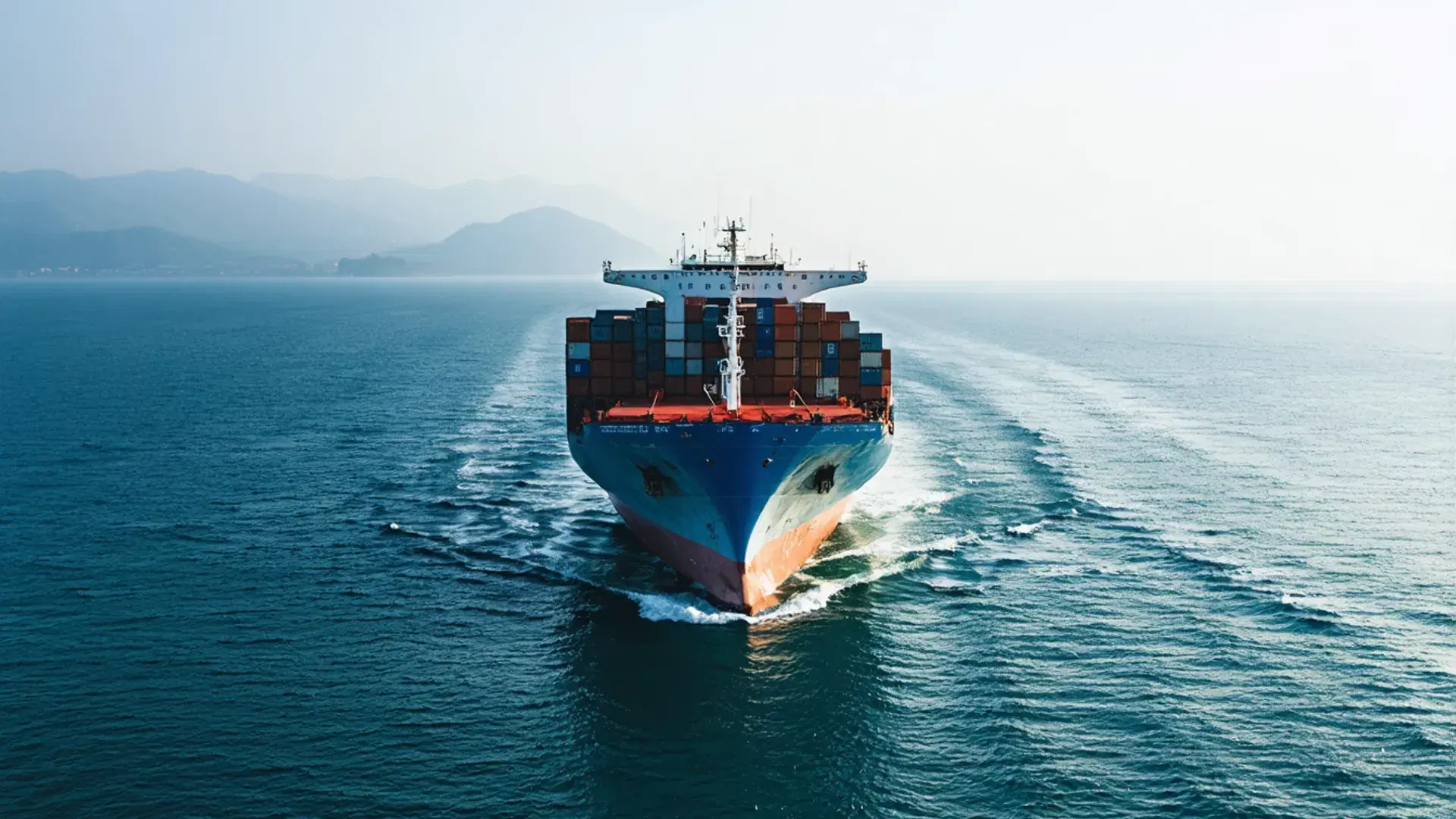 Container ship at dawn on the open sea — maritime compliance ledger imagery